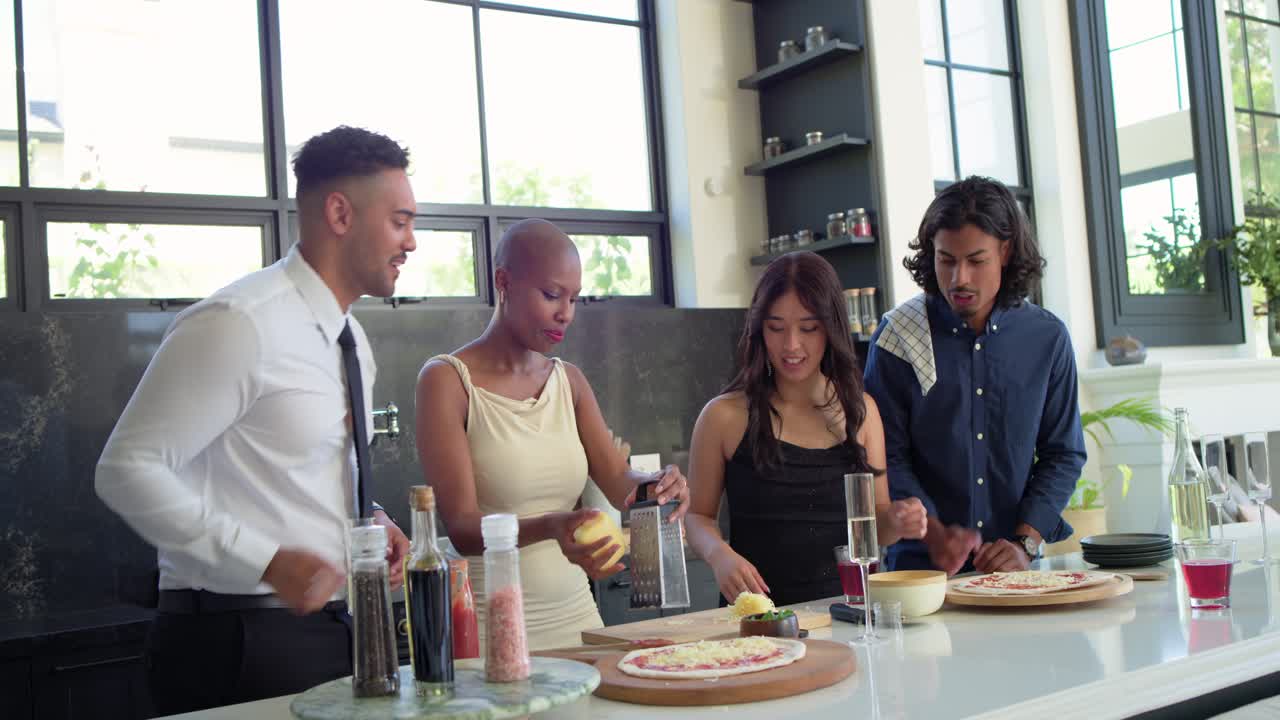 Friends gathering at kitchen island, man arriving with flute joining using grater and making pizzas