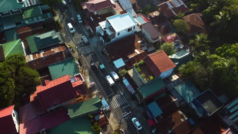 Drone-ascending-above-vehicles-on-the-streets-of-the-Calabarzon-region,-sunny-afternoon-in-Philippines