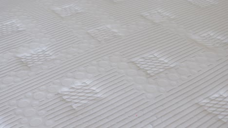 close-up of a white quilted mattress texture