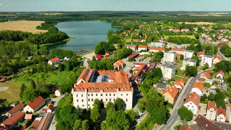 aerial view of górzno castle and town by górzno lake, poland