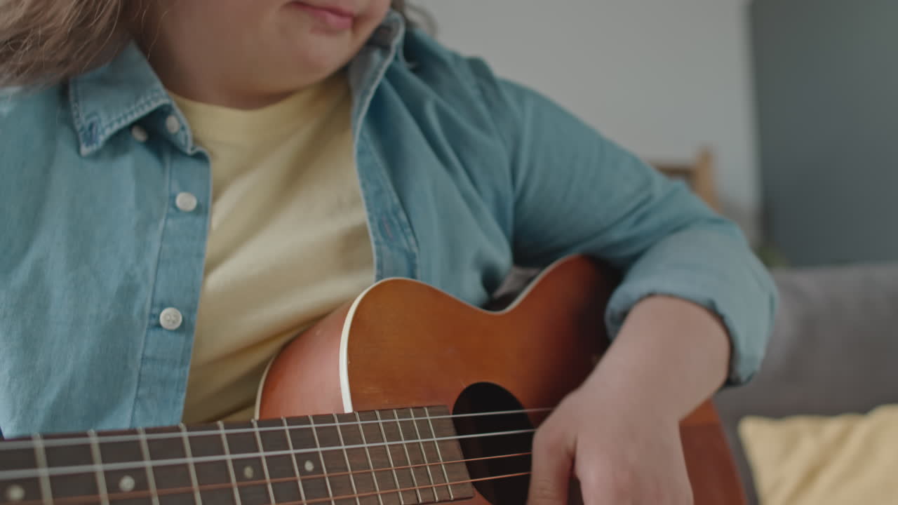 Person with Down Syndrome Playing Guitar