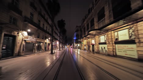 main street in montpellier by night empty traffic lanes