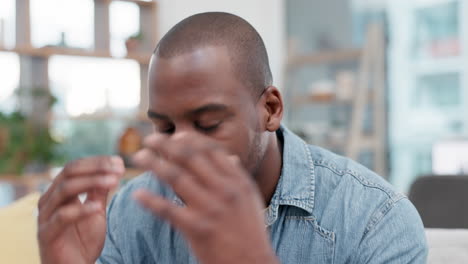 Stress,-headache-and-black-man-on-sofa-with-temple