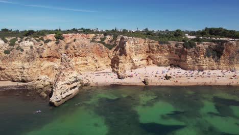 Flying-over-Praia-Da-Marinha--in-Algarve,-Portugal