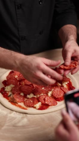 chef preparing a pepperoni pizza