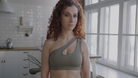 Woman in workout clothes in a kitchen