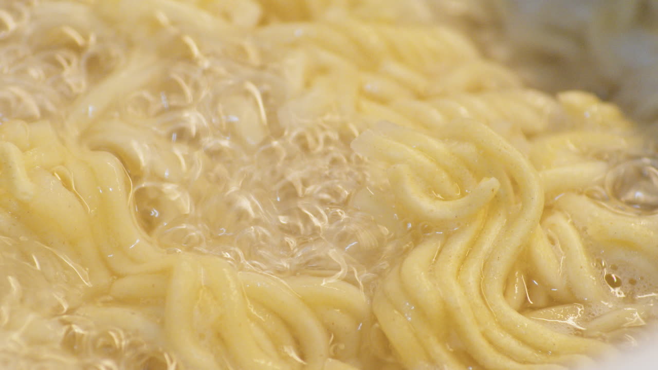 Instant Ramen Noodles Cooked In A Boiling Water With Bubbles