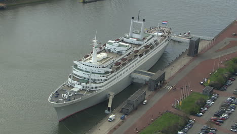 aerial rotating shot with zoom out of the ss rotterdam docked in port