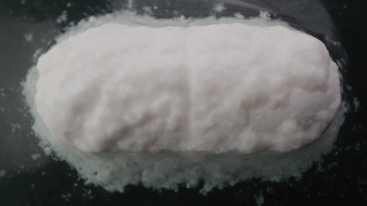 White Pill on Dark Surface