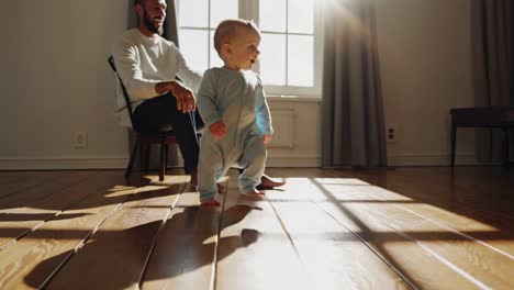 baby learning to walk with dad
