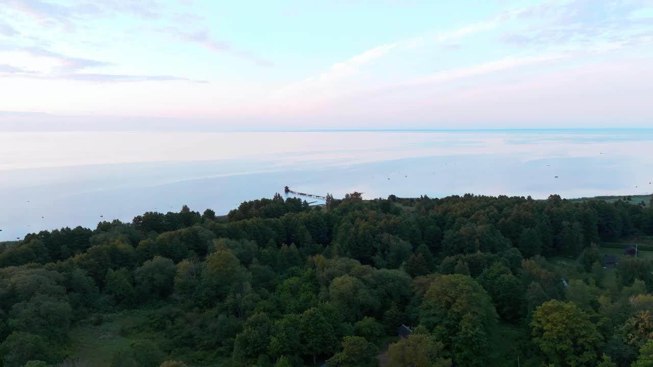 Calm Baltic sea with structures near the coastline and inland