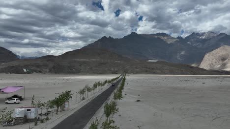 aerial view of sarfaranga desert with road leading towards mountains in background