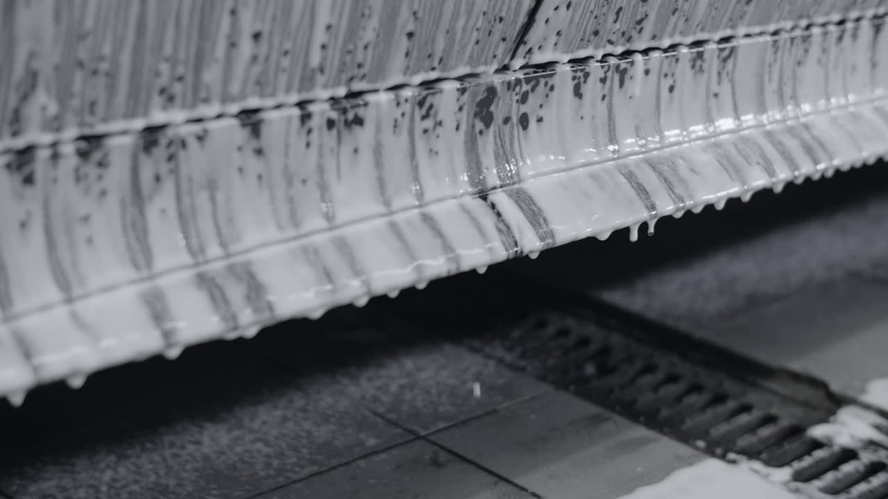 Car Undergoing Foam Wash in a Wash Bay