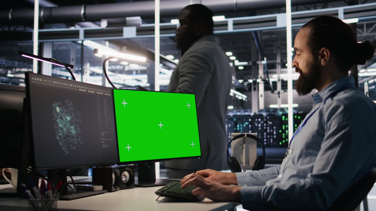 Vertical video Data center technician doing software updates using green screen mockup computer