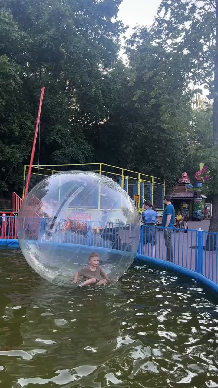 Child playing in a water walking ball