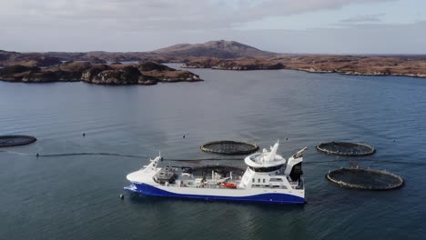 circling drone shot of a fish farming well-boat near the isle of uist