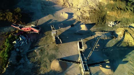 High angle view of separator tracks and heavy machinery creating piles of dirt and soil fill