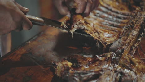 a man slices a rack of ribs