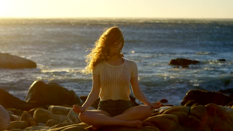 woman performing yoga on the beach 4k