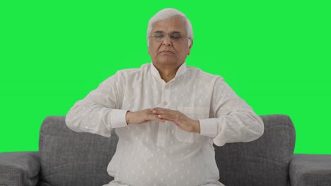 Relaxed-Indian-old-man-doing-breathe-in-breathe-out-exercise-Green-screen