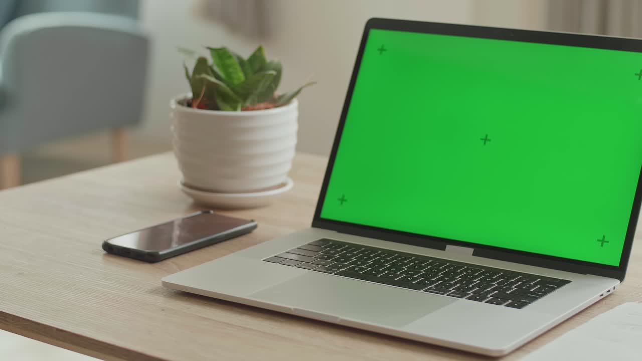 Laptop With Green Mock-Up Screen On The Table In Living Room, Video In 4K