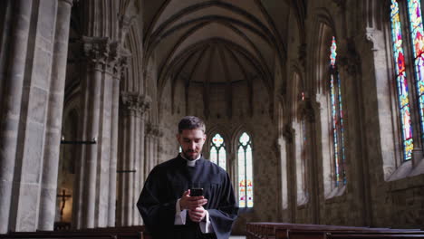 priest using smartphone in a church