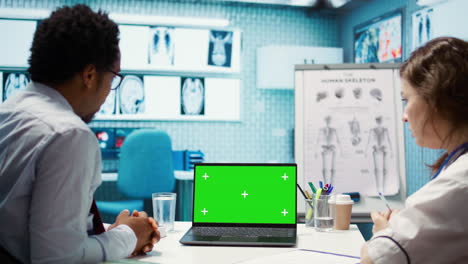 medical expert pointing at isolated chroma key display in cabinet