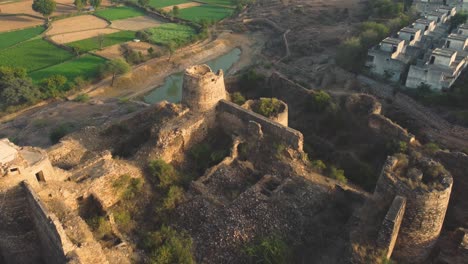 aerial reveal shot of a gurjar dynasty indian fort in gwalior , madhya pradesh