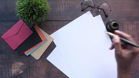 writing a letter at a wooden desk