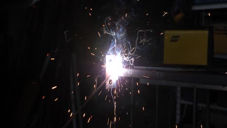 man welding in slow motion in his workshop.