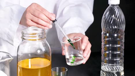 A scientist conducts a vibrant chemical reaction using liquids and a pipette in a laboratory setting