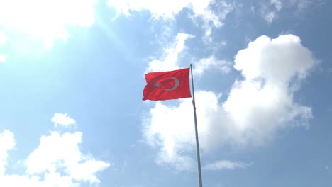turkish flag waving in blue sky outdoors