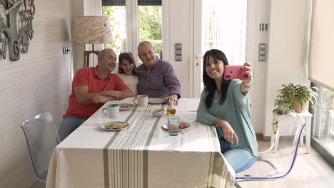 Non-normative family taking a selfie together while having breakfast