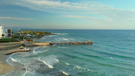 Coastal-scene-with-a-wooden-bridge-in-Protaras-during-sunset---aerial