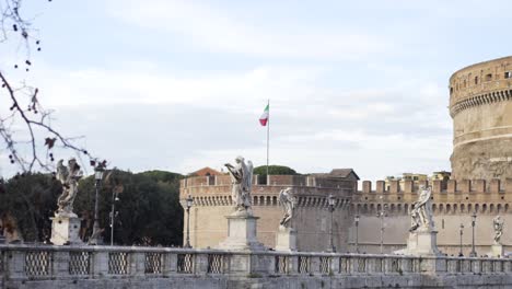 bridge in rome with statues and castle