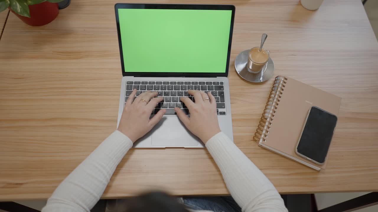 Woman Working on Laptop in a Cafe