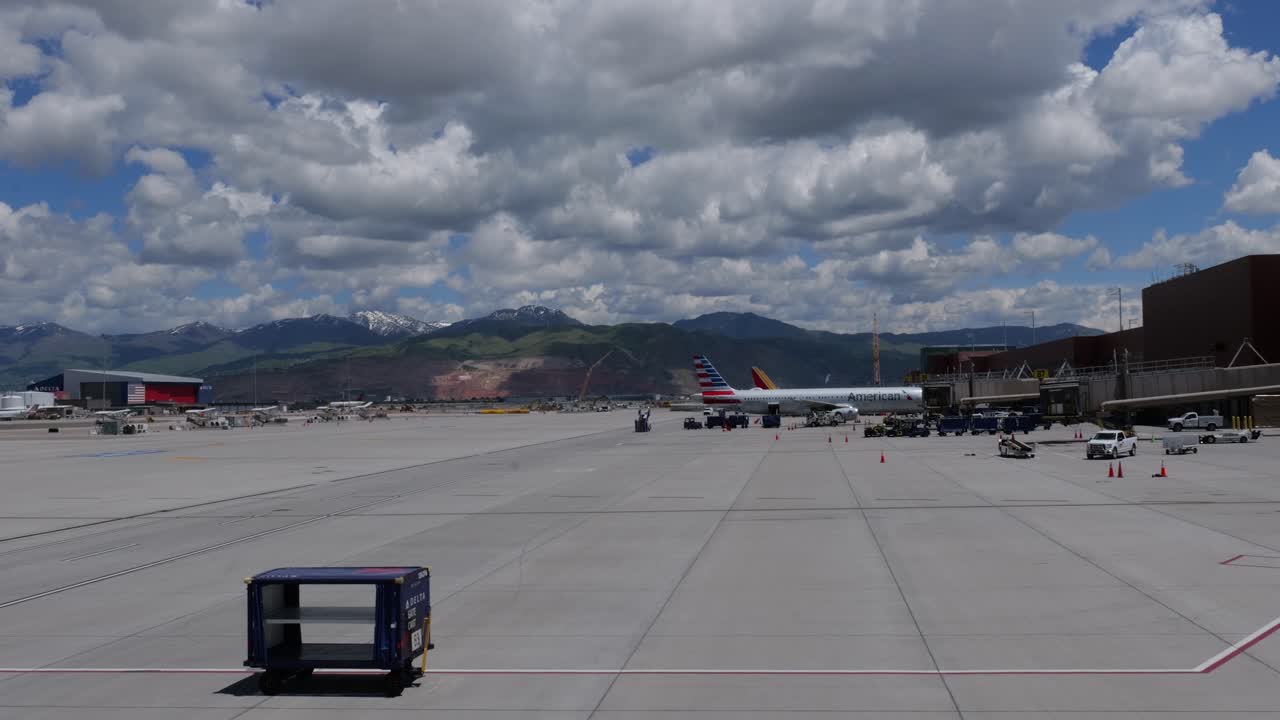 American Airlines Airplane at Airport Gate with Mountains in Background