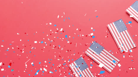 animation of confetti falling over flags of united states of america on red background