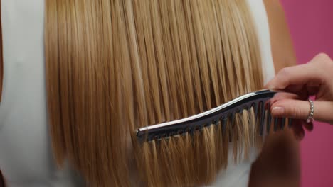 woman getting her hair combed