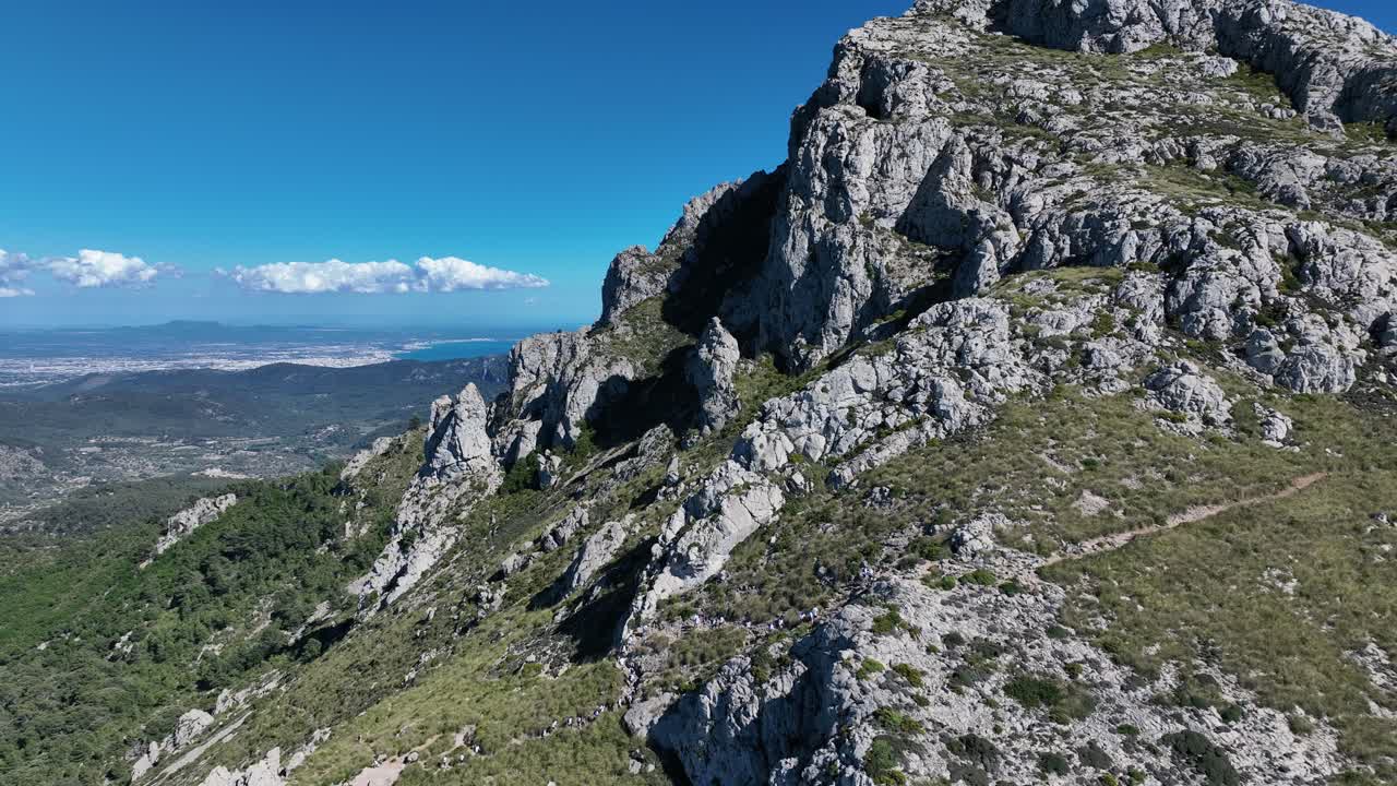 increíble vista de la montaña por avión no tripulado en mallorca y la gente caminando a la cima