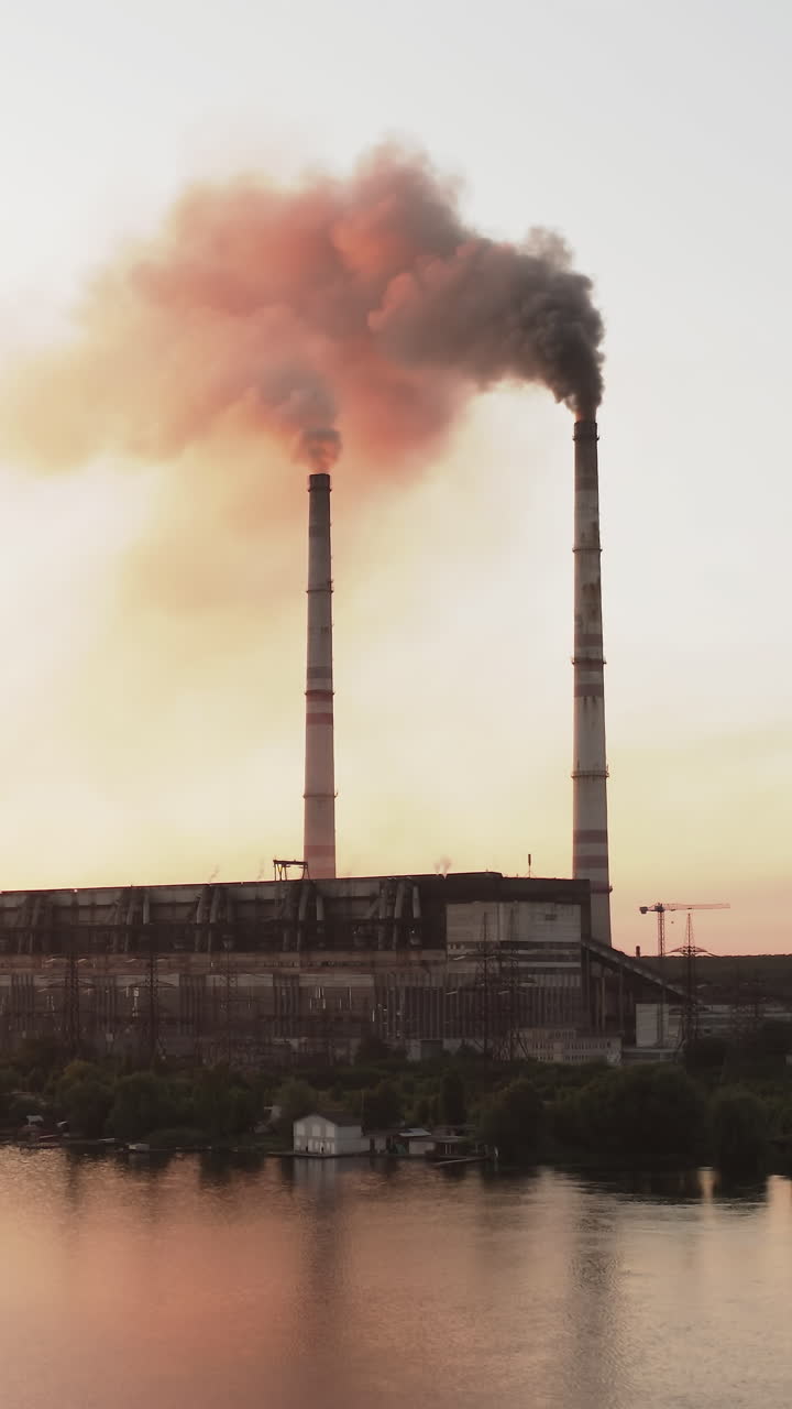 Industrial zone with large chimney. Aerial view of high smoke stack with smoke emission
