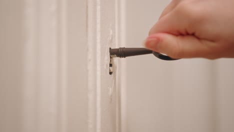 a person is opening a closet using antique key