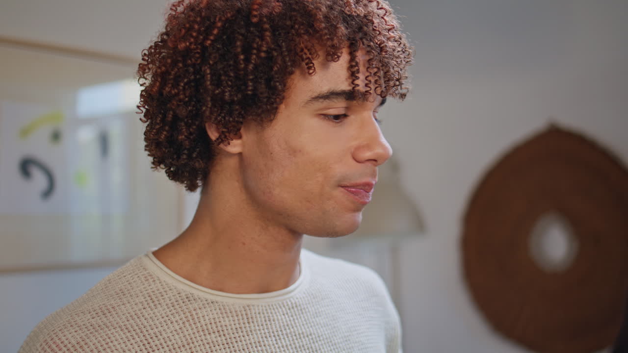 Young guy sipping alcohol beverage resting home party closeup. Smiling student