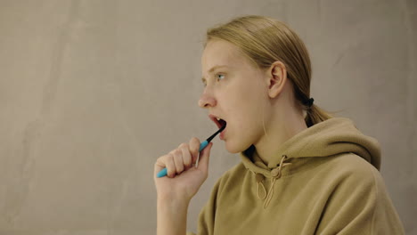 teenage girl brushing her teeth