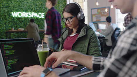 young hispanic woman engineer developing software app using digital laptop computer typing code multi ethnic team working in modern office