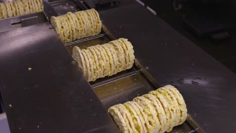 Shot-of-a-moving-conveyor-with-einkorn-cakes