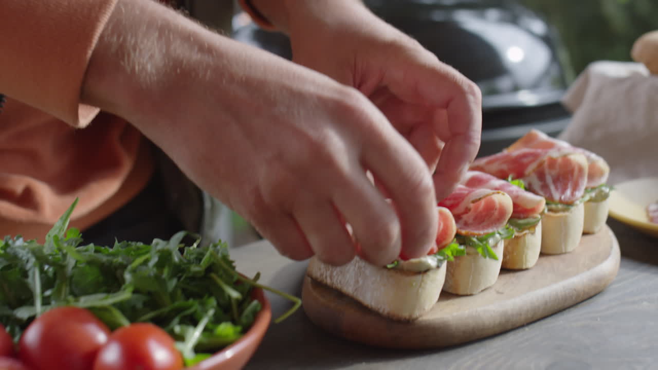 Adding Tomatoes to Bruschettas with Bacon