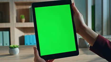 lady boss watching green screen tablet in workplace closeup. unknown freelancer