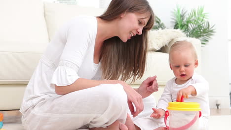 Baby-putting-a-red-dice-into-bucket-