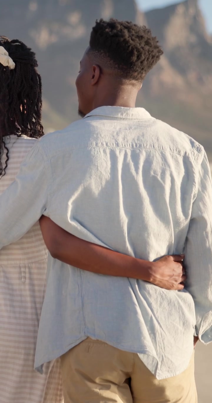 Young Couple Embracing and Looking at Each Other on the Beach